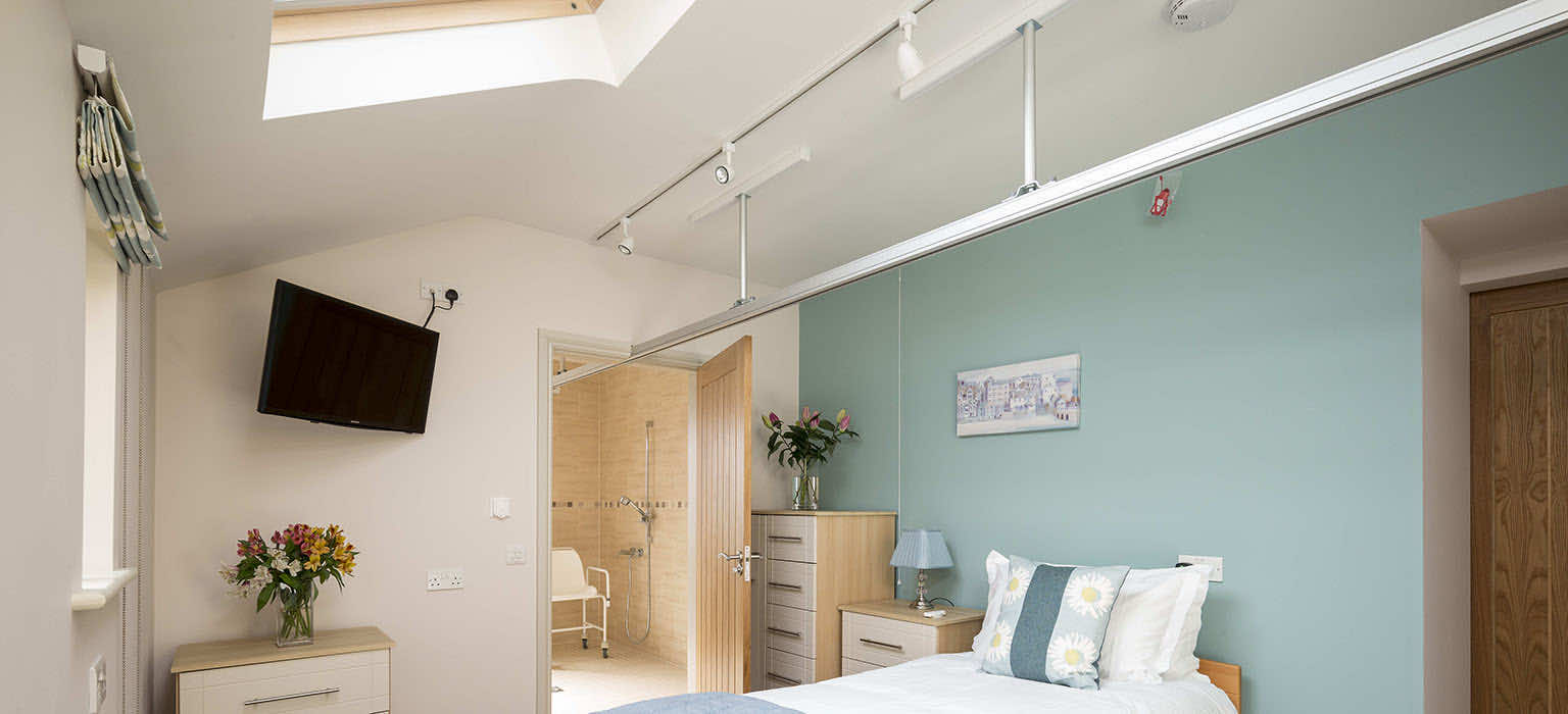 Accessible bedroom with ceiling track hoist in a North York Moors cottage